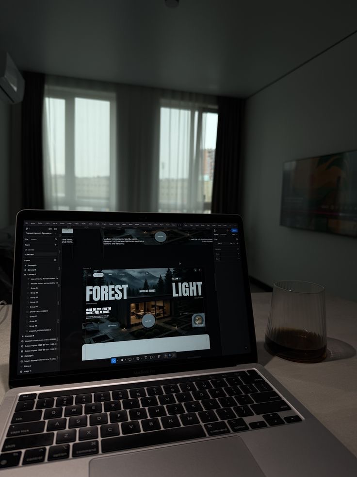 A website design open on a laptop, a home page laid out in the editor